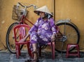 An old lady is taking a break in hoi an, Quang Nam Province, Vietnam Royalty Free Stock Photo